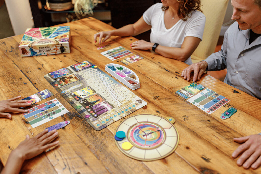 the game setup on a wooden kitchen table