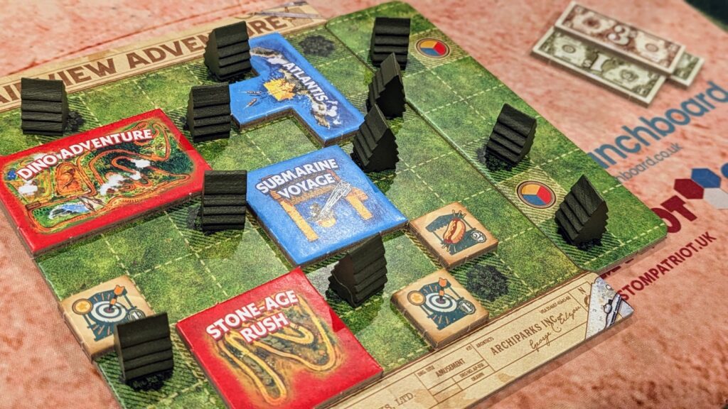 a close-up view of a player board with wooden trees and attraction tiles